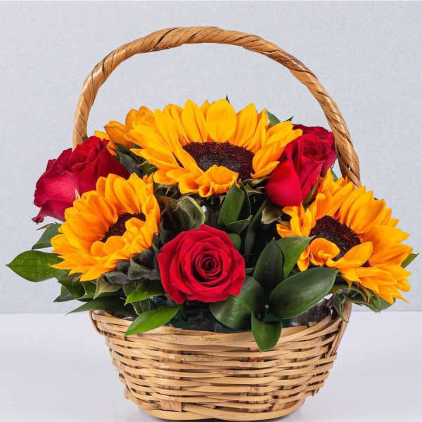 Basket of red roses and yellow sunflowers
