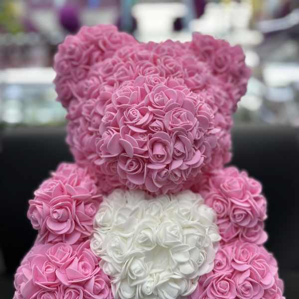 Pink and white teddy bear made of small rose-like flowers