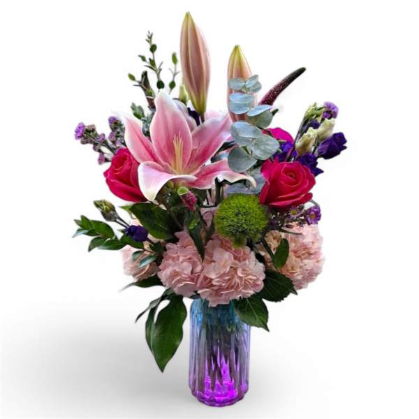 Pink lilies and roses in a purple glass vase