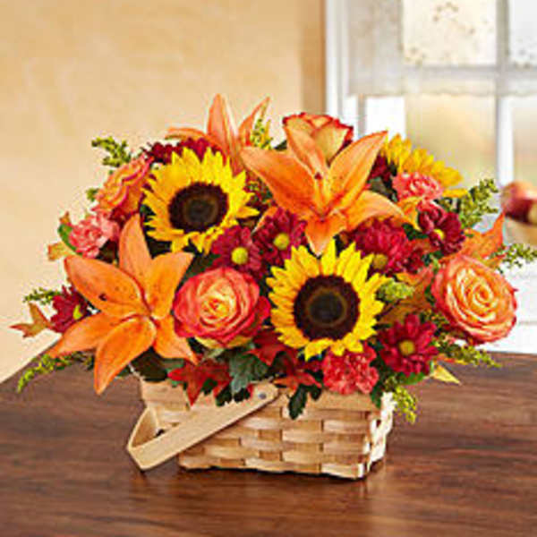 Basket arrangement with sunflowers, orange lilies, and roses