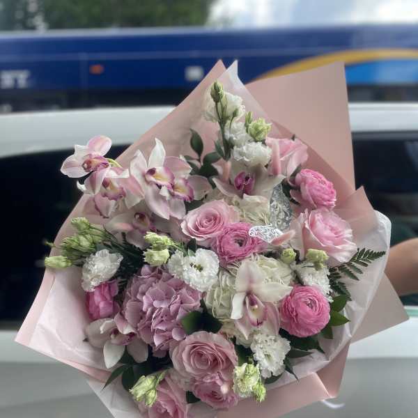 Pink and white mixed bouquet wrapped in pale pink paper