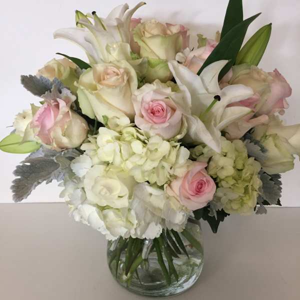 Bouquet of white and pale pink flowers in a glass vase