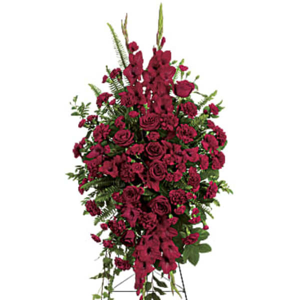 Tall standing spray of deep red flowers on a metal easel