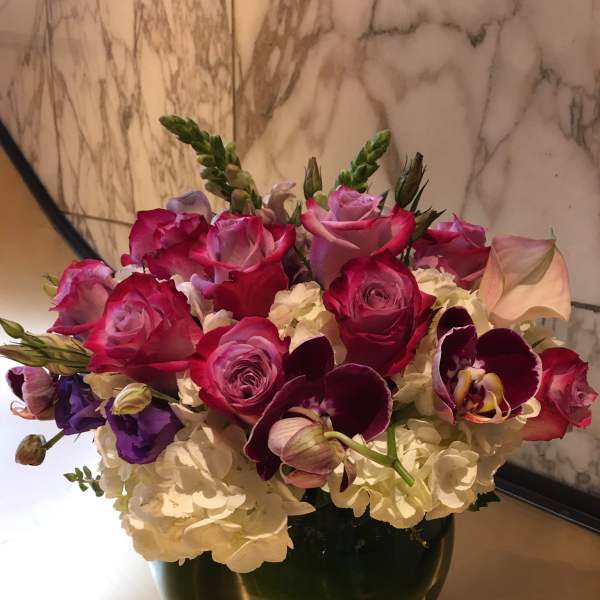 Pink and purple mixed bouquet in a dark vase