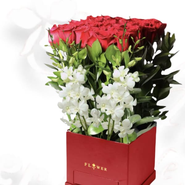 Red roses and white orchids in a red box