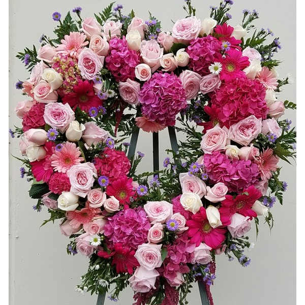 Heart-shaped floral wreath with pink roses and gerbera daisies