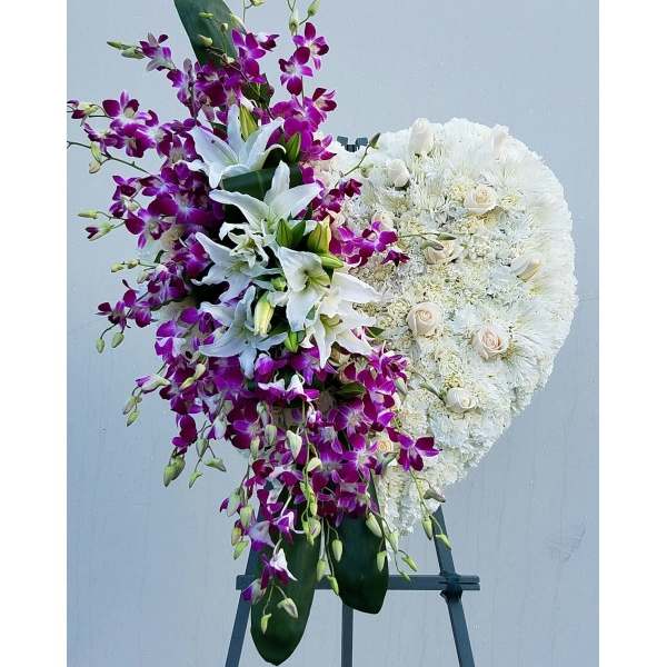 Standing floral spray with white lilies, purple orchids, and white roses