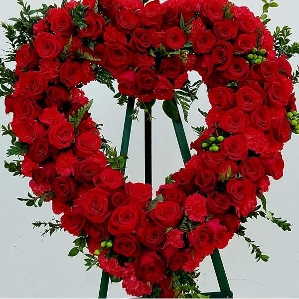 Heart-shaped red rose wreath on a standing easel
