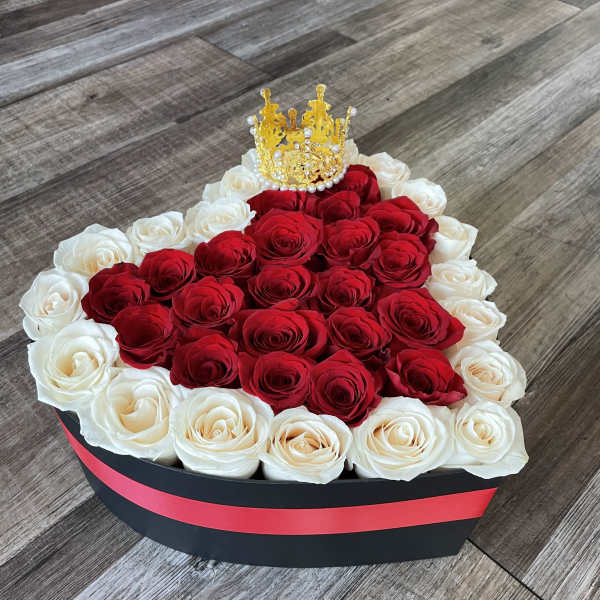 Heart-shaped box of red and white roses with a gold crown topper