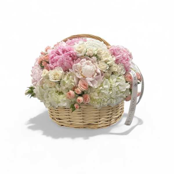 Pink and white flower arrangement in a wicker basket