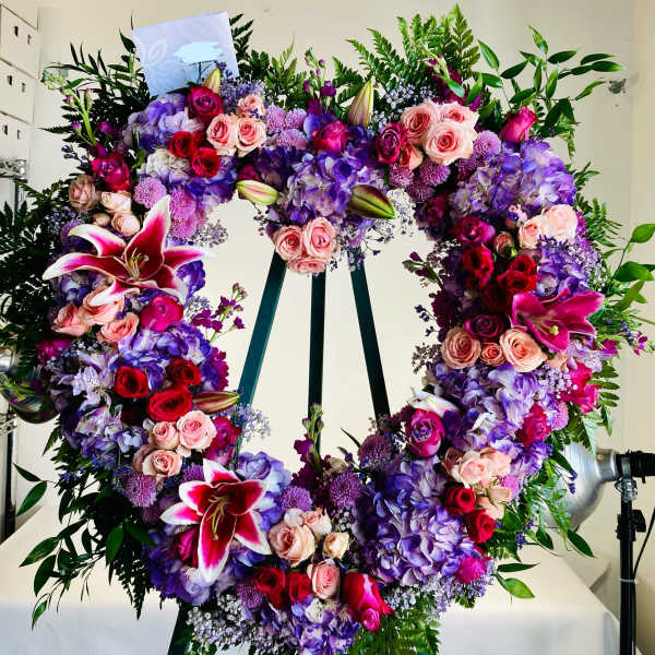 Heart-shaped floral wreath with pink, purple, and red blooms