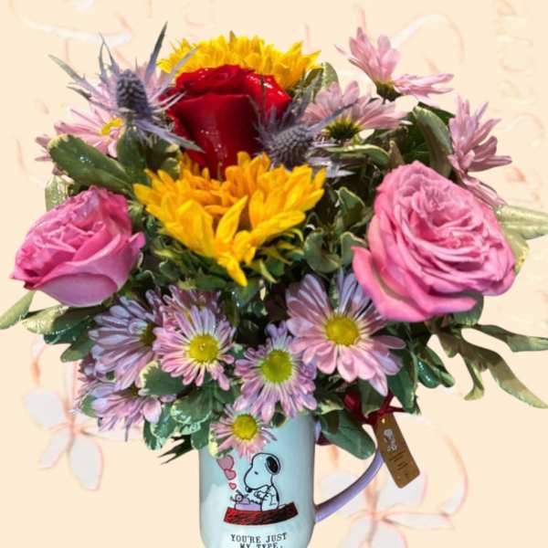 Bouquet of mixed flowers in a Snoopy mug vase