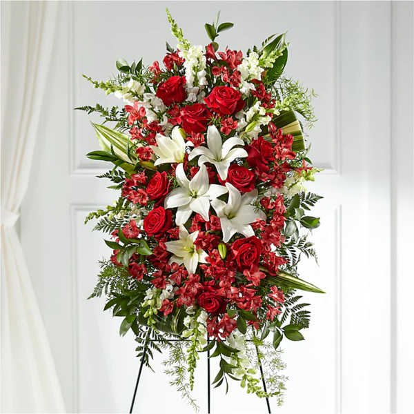 Standing spray of red roses and white lilies on an easel