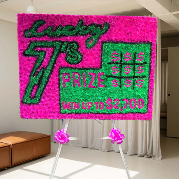 Bright pink and green prize sign on an easel