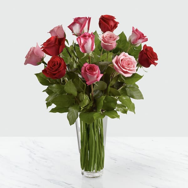 Bouquet of red and pink roses in a clear glass vase