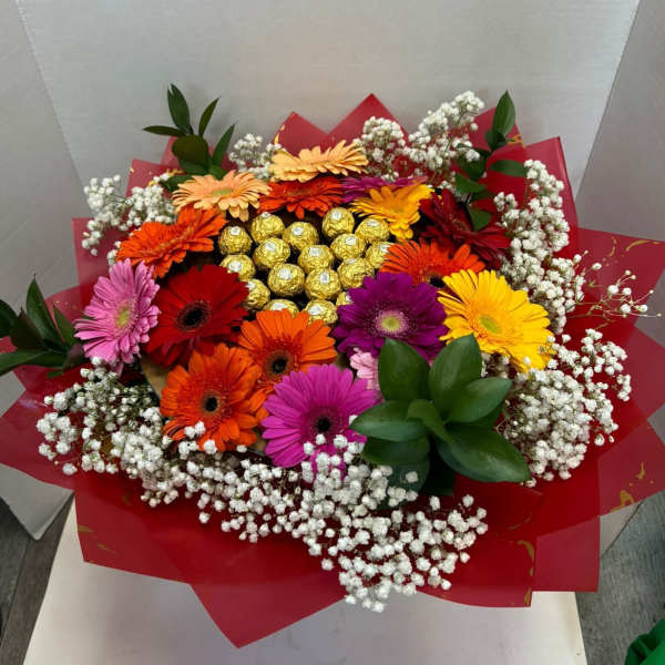 Colorful gerbera daisy bouquet with baby’s breath and gold chocolates