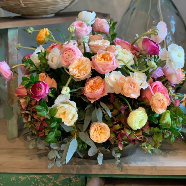 Mixed bouquet of pink, peach, white, and yellow ranunculus
