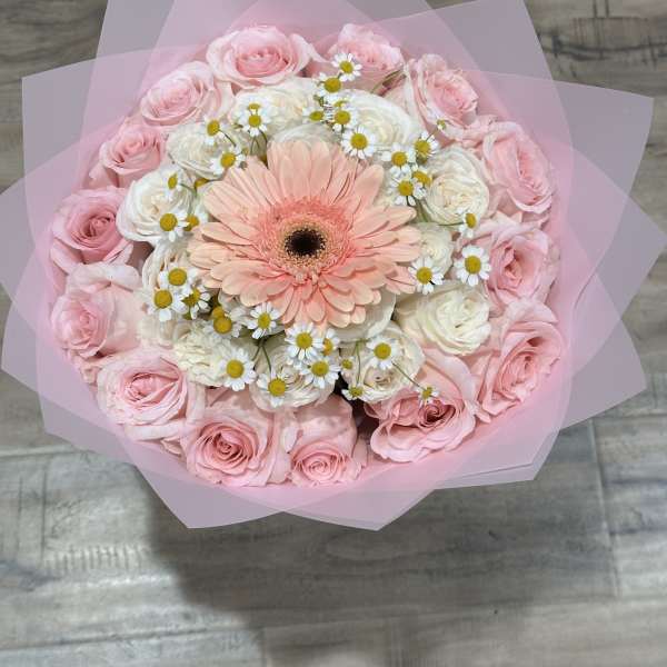 Pink and white bouquet with a peach gerbera daisy in pink wrap