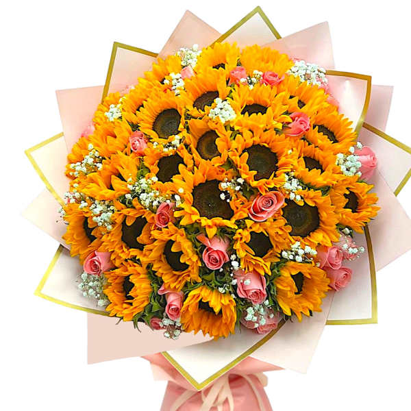 Bouquet of sunflowers and pink roses wrapped in pale pink paper