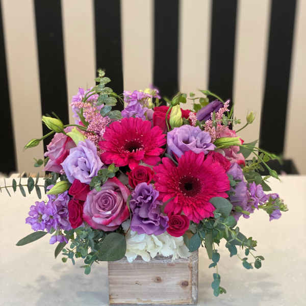 Pink and purple bouquet in a wooden box
