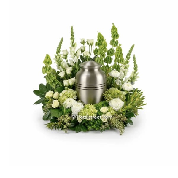 White floral urn arrangement surrounding a silver urn