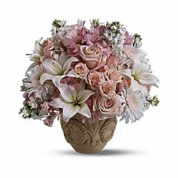 Pink and white floral arrangement in an ornate vase