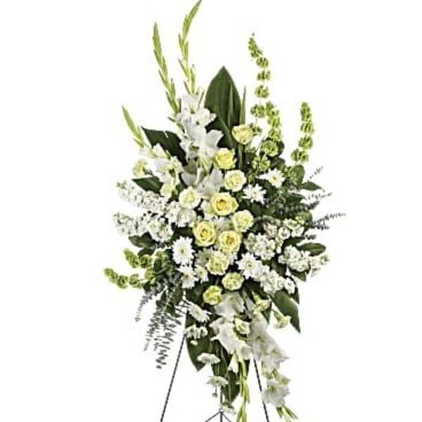 Tall white and pale yellow floral standing spray on an easel