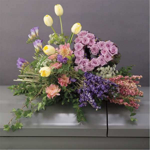 Lavender rose heart arrangement with yellow tulips and mixed flowers