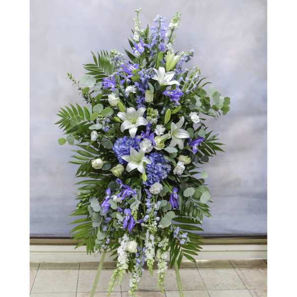 Tall blue and white floral standing spray on an easel