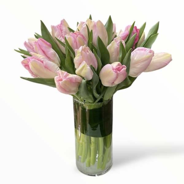Pink tulips arranged in a clear glass vase