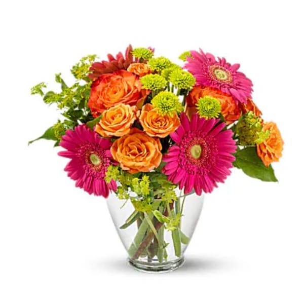 Bouquet of orange roses and pink gerbera daisies in a clear glass vase