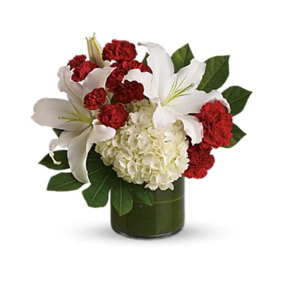 White lilies and red carnations arranged in a green vase