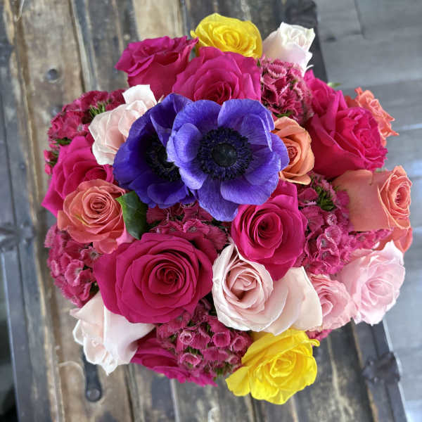 Bright mixed bouquet of roses and purple anemones