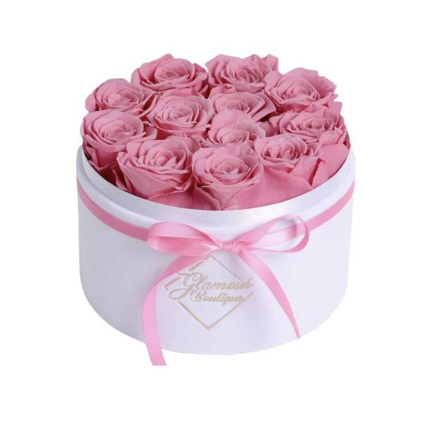 Pink roses arranged in a white round box with a pink ribbon