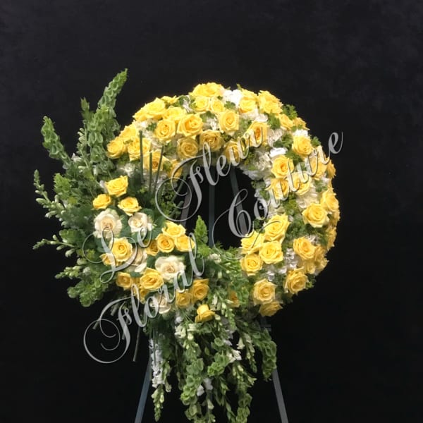 Yellow and white rose wreath on a standing easel