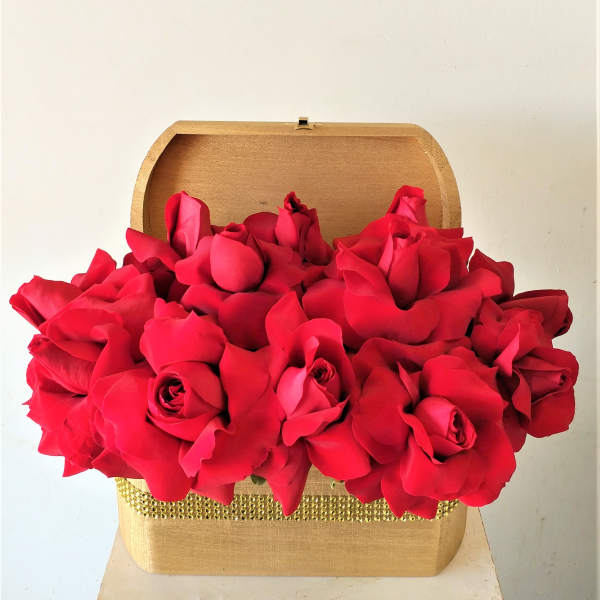 Red roses arranged in a gold gift box