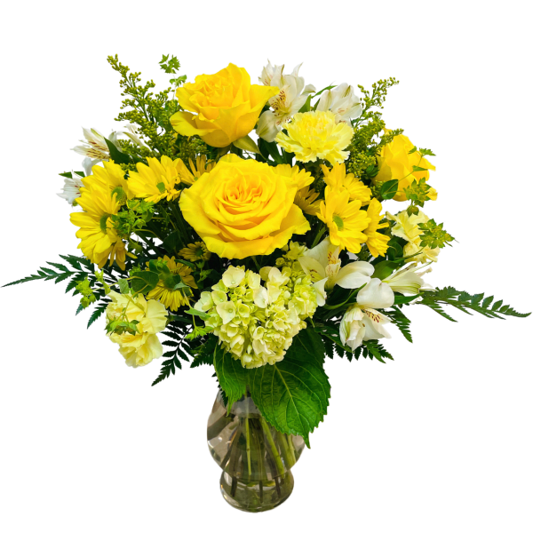Yellow roses and white alstroemeria in a clear glass vase
