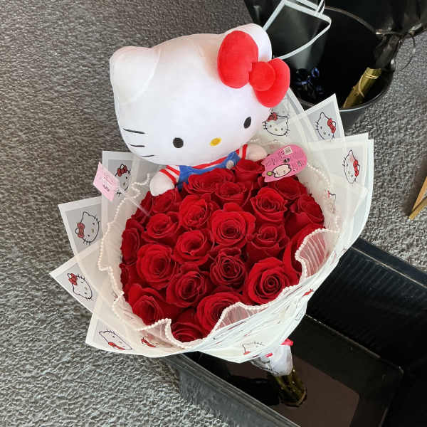 Bouquet of red roses with a Hello Kitty plush topper