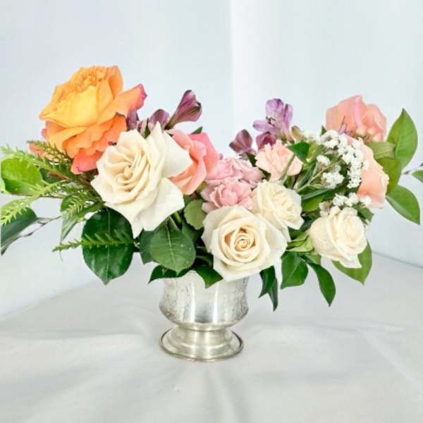 Mixed bouquet of roses and alstroemeria in a silver vase