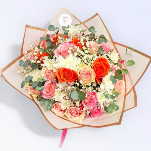 Bouquet of pink and orange roses with white flowers and eucalyptus