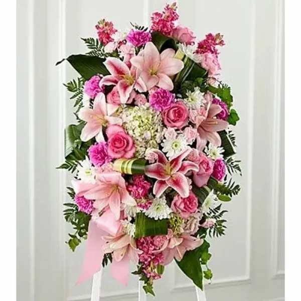 Pink floral standing spray with lilies, roses, and carnations