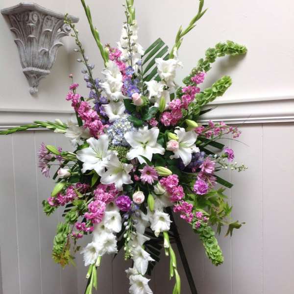 Tall standing floral spray with white lilies and pink-purple flowers