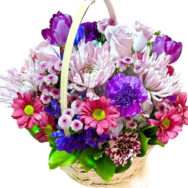 Basket of pink, purple, and white flowers with a handle