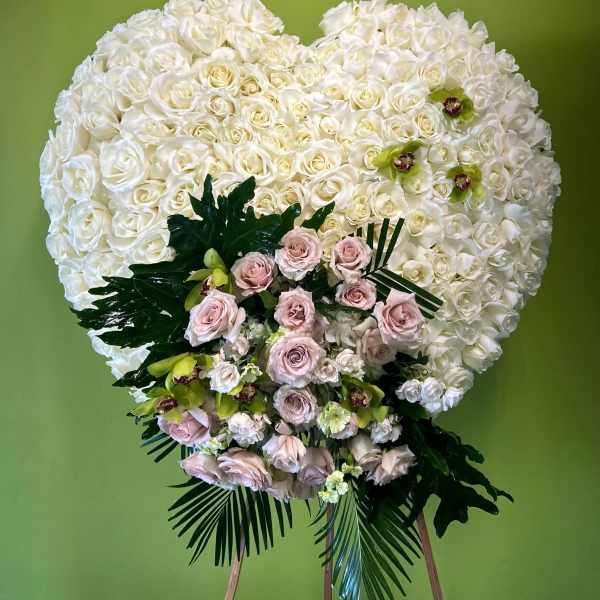 Large white rose heart arrangement with pale pink roses and green orchids