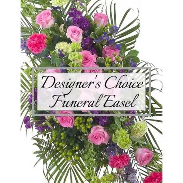 Funeral easel spray with pink roses, purple flowers, and greenery