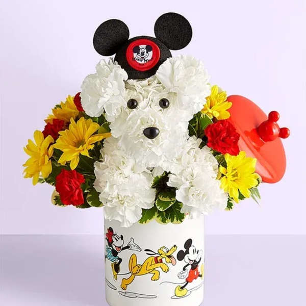Mickey Mouse-shaped floral arrangement in a printed container with a red balloon
