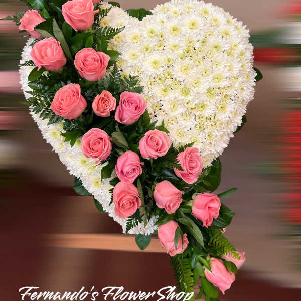Heart-shaped standing spray of white mums with cascading pink roses on one side