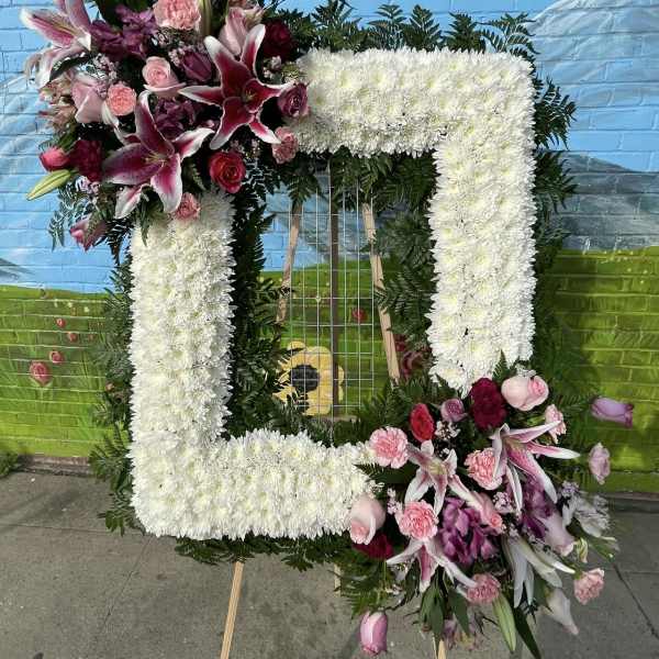 Large floral number-shaped arrangement with white and pink flowers