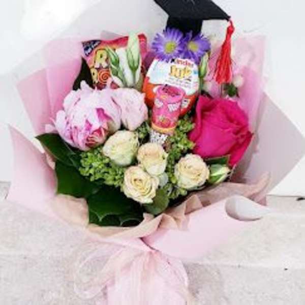 Pink bouquet with roses and a graduation cap topper
