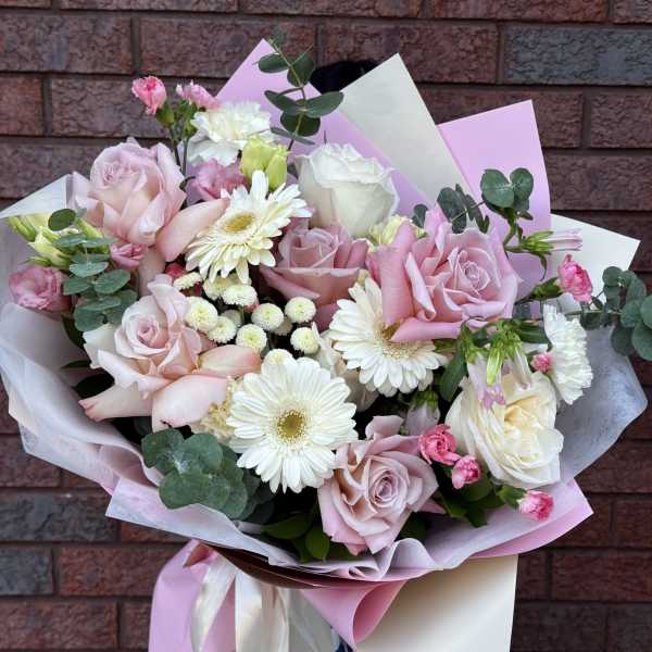 Bouquet of pink and white roses with white daisies and eucalyptus